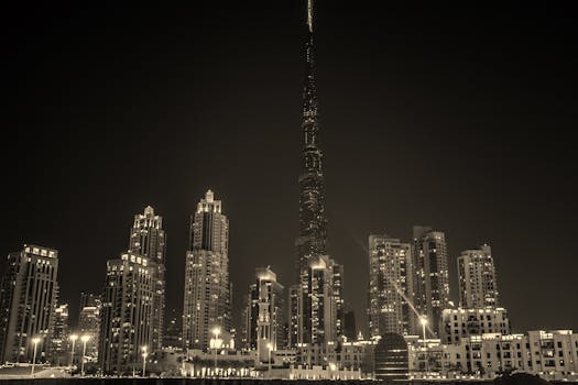 Captivating black and white night view of Dubai's skyline with the iconic Burj Khalifa illuminated.